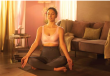 A confident woman wearing a soft-cup bra, smiling in natural light.