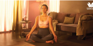 A confident woman wearing a soft-cup bra, smiling in natural light.